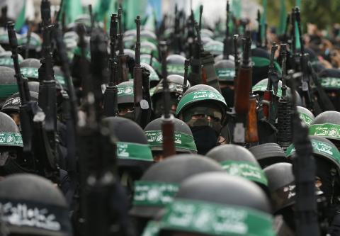 Palestinian members of al-Qassam Brigades, the armed wing of the Hamas movement, take part in a military parade marking the 27th anniversary of Hamas' founding, in Gaza City, December 14, 2014. PHOTO BY REUTERS/Mohammed Salem