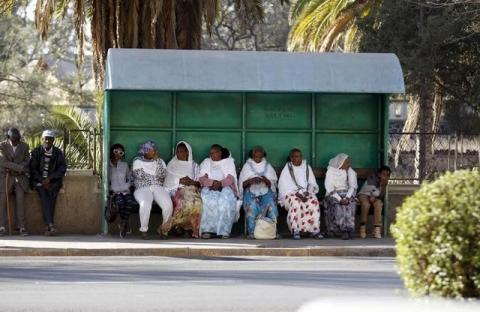Passangers wait for public transport at a bus-stop in Eritrea's capital Asmara, February 20, 2016. PHOTO BY REUTERS/Thomas Mukoya