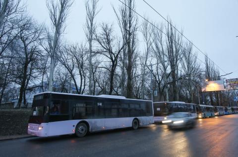 Empty buses, intended for internally displaced persons (IDPs) from the village of Debaltseve, are parked along a roadside, before driving to the village to evacuate the residents, in Makiivka (Makeyevka), eastern Ukraine, February 6, 2015. PHOTO BY REUTERS/Maxim Shemetov