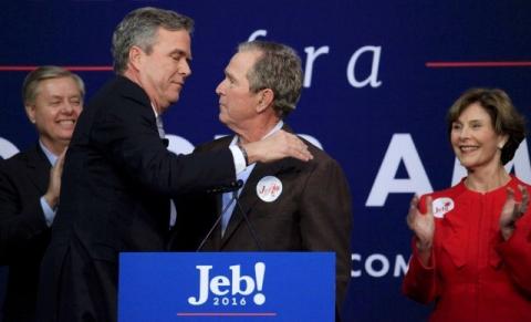 Republican U.S. presidential candidate Jeb Bush (2nd L) hugs his brother former President George W. Bush (C) as his former 2016 presidential campaign rival U.S. Senator Lindsey Graham (L) of South Carolina and former first lady Laura Bush (R) look on at a campaign rally in North Charleston, South Carolina, February 15, 2016. PHOTO BY REUTERS/Randall Hill