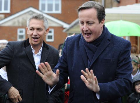 Britain's Prime Minister David Cameron (R) arrives with sports broadcaster Gary Lineker at St Brigid's Catholic Primary School in Birmingham, central England