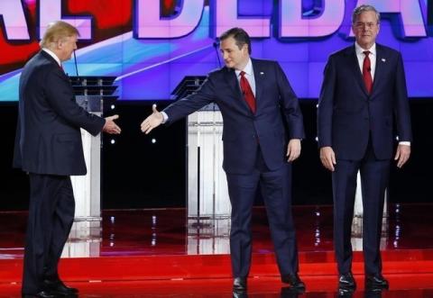 Republican U.S. presidential candidate businessman Donald Trump (L) reaches out to shake hands with Senator Ted Cruz as former Governor Jeb Bush (R) stands beside Cruz before the start of the Republican presidential debate in Las Vegas, Nevada, December 15, 2015. PHOTO BY REUTERS/Mike Blake