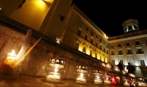 Candles are seen during a meeting, marking an unofficial day of commemoration for victims of political repression, at a building of the KGB state security committee in Minsk, Belarus, October 29, 2015. PHOTO BY REUTERS/Vasily Fedosenko