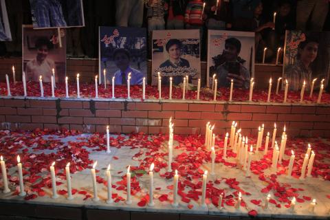 People place pictures of victims of the Pakistan Taliban attack on the Army Public School, during a candle light vigil in Islamabad, December 18, 2014. PHOTO BY REUTERS/Faisal Mahmood