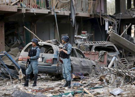 Afghan policemen stand guard at the site of a suicide truck bomb in Kabul, Afghanistan, August 7, 2015. PHOTO BY REUTERS/Omar Sobhani