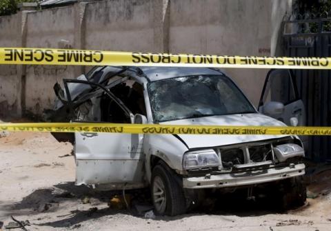 A destroyed car is behind a police cordon after what authorities said was a car bomb attack which killed Muhayadin Mohamed, who was Somalia's former defence minister and an adviser to the speaker of Somalia's parliament, in the capital Mogadishu, February 15, 2016. PHOTO BY REUTERS/Feisal Omar