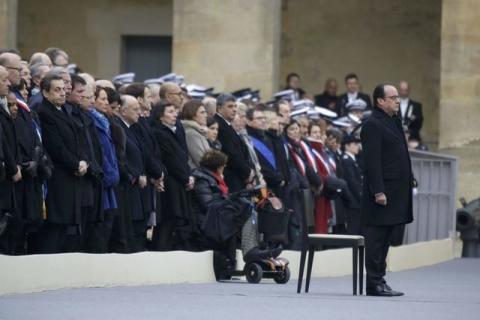 French President Francois Hollande (R) stands in front of members of the French government, officials and guests during a ceremony to pay a national homage to the victims of the Paris attacks at Les Invalides monument in Paris, France, November 27, 2015. PHOTO BY REUTERS/Philippe Wojazer