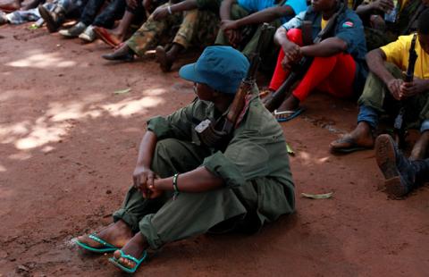 A former child soldier holds a gun as they participate in a child soldiers' release ceremony, outside Yambio, South Sudan, August 7, 2018. PHOTO BY REUTERS/Andreea Campeanu