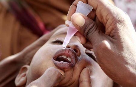 A newly arrived Somali refugee child receives a polio drop at the Ifo extension refugee camp in Dadaab, near the Kenya-Somalia border, August 1, 2011. PHOTO BY REUTERS/Thomas Mukoy