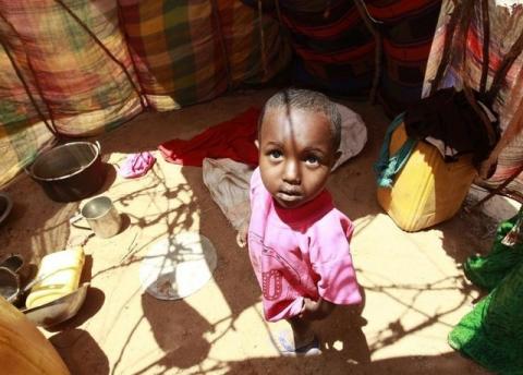 A displaced child stands inside their makeshift shelter structure at the Qansahaley settlement camp in Dollow town, along the Somalia-Ethiopia border, August 30, 2011. PHOTO BY REUTERS/Thomas Mukoya