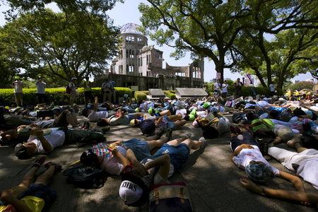 Children perform a die-in in front of the Atomic Bomb Dome in Hiroshima, western Japan, August 5, 2015. PHOTO BY REUTERS/Thomas Peter