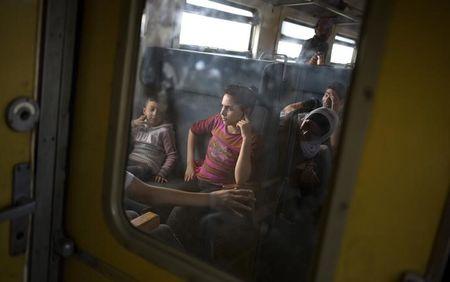 Migrant children sit inside a train after crossing the Macedonian-Greek border near Gevgelija, Macedonia, September 6, 2015. PHOTO BY REUTERS/Stoyan Nenov
