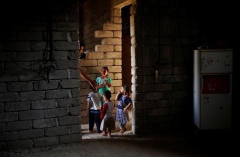 Nine-year-old Iraqi girl Meriam plays with her three half-siblings in a house, east of Mosul, Iraq, July 28, 2017. PHOTO BY REUTERS/Suhaib Salem