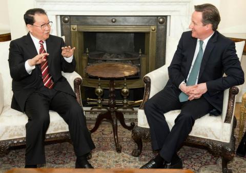 Li Changchun, a member of China's Standing Committee of the Political Bureau (L) speaks to Britain's Prime Minister David Cameron during their meeting at number 10 Downing Street in London
