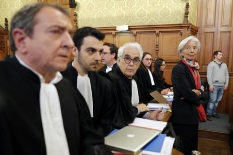 Managing Director of the International Monetary Fund (IMF) Christine Lagarde (R) stands with her lawyers before the start of her trial about a state payout in 2008 to a French businessman, at the courts in Paris, France, December 12, 2016. PHOTO BY REUTERS/Philippe Wojazer