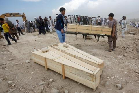Afghan men carry empty coffins for the victims of yesterday's suicide attack in Kabul, Afghanistan, July 24, 2016. PHOTO BY REUTERS/Omar Sobha