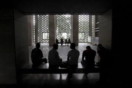 People sit in the hall of the court of Abidjan July 2, 2015. PHOTO BY REUTERS/Luc Gnago