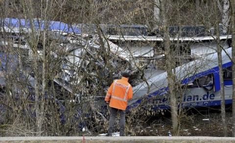 A rescuer stands at the site of the crash of two trains near Bad Aibling in southwestern Germany, February 10, 2016. PHOTO BY REUTERS/Lukas Barth