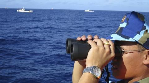 A crewman from the Vietnamese coastguard ship 8003 looks out at sea as Chinese coastguard vessels give chase to Vietnamese ships that came close to the Haiyang Shiyou 981, known in Vietnam as HD-981, oil rig in the South China Sea, July 15, 2014. PHOTO BY REUTERS/Martin Petty