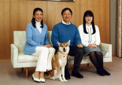 Japan's Crown Prince Naruhito (C) smiles as he poses for a photograph with his wife Crown Princess Masako (L), daughter Princess Aiko (R) and their pet dog Yuri at his residence Togu Palace in Tokyo February 11, 2015. PHOTO BY REUTERS/Imperial Household Agency of Japan