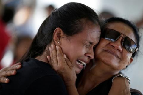 A woman is crying after receiving the information that her brother was one of the inmates who died during a prison riot, in front of the Medical Legal Institute in Manaus, Brazil, January 3, 2017. PHOTO BY REUTERS/Ueslei Marcelino
