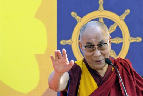 Exiled Tibetan spiritual leader, the Dalai Lama, addresses a gathering with the theme "A Human Approach to Peace and the Individual" at a stadium in the northeastern Indian city of Guwahati