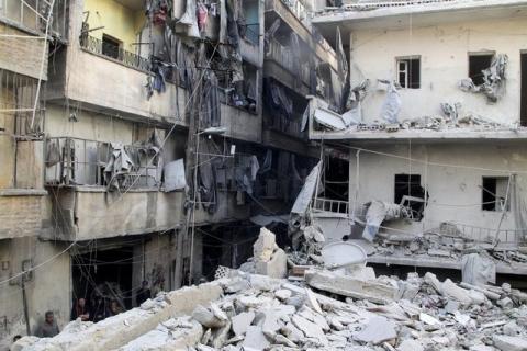 Residents and Civil Defense members inspect damage after an air strike on the rebel held al-Saliheen district in Aleppo, Syria, March 11, 2016. PHOTO BY REUTERS/Abdalrhman Ismail
