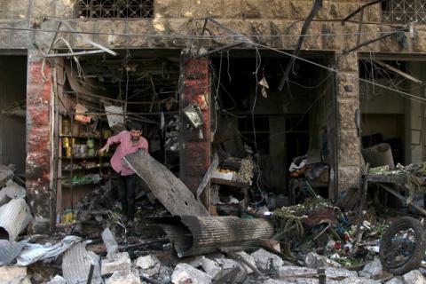 A man inspects damaged shops after an airstrike on a market in the town of Maarat al-Numan in the insurgent stronghold of Idlib province, Syria, April 19, 2016. PHOTO BY REUTERS/Ammar Abdullah