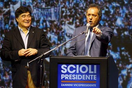 Argentina's ruling party candidate Daniel Scioli (R) next to his vice-presidential candidate Carlos Zannini wave to supporters after elections in Buenos Aires, October 25, 2015. PHOTO BY REUTERS/Martin Acosta