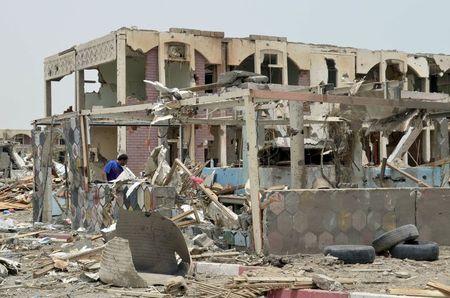 A man checks damage in a residential area one day after it was hit by a Saudi-led air strike in Yemen's western city of Mokha, July 26, 2015. PHOTO BY REUTERS/Stringer