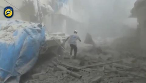 A still image taken on September 7, 2016 from a video posted on social media said to be shot in Aleppo's Al Sukari on September 6, 2016, shows a civil defense member making his way through debris, after a suspected chlorine gas attack, Syria. PHOTO BY REUTERS/Social Media