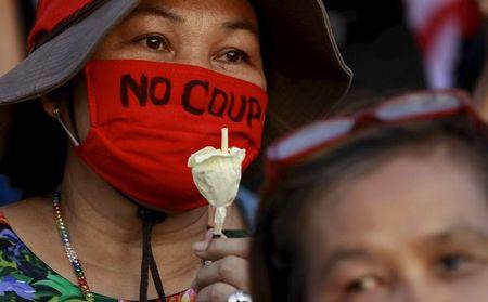 A demonstrator from the New Democracy Movement (NDM) group wears a mask during a rally at the Democracy Monument in Bangkok, Thailand, September 19, 2015. PHOTO BY REUTERS/Chaiwat Subprasom