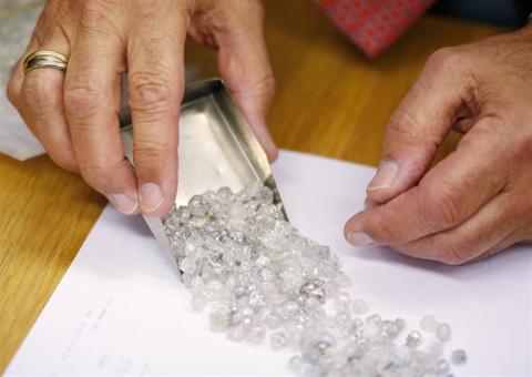 Diamond buyer Elliot Tannenbaum, from the Leo Schachter Diamond Group, looks at uncut diamonds