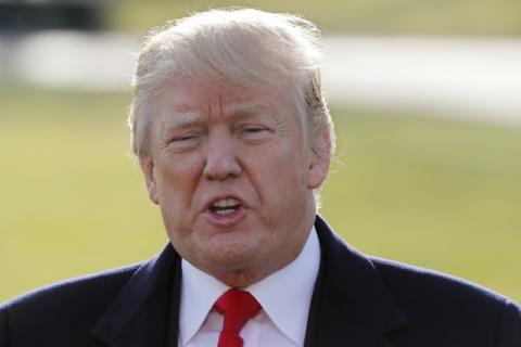 U.S. President Donald Trump speaks to the media as he departs the White House to visit Walter Reed National Military Medical Center in Washington, U.S., December 21, 2017. PHOTO BY REUTERS/Jim Bourg