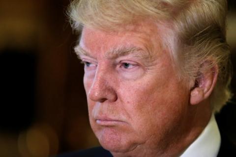 U.S. President-elect Donald Trump listens to questions from reporters in the lobby at Trump Tower in New York, U.S., January 9, 2017. PHOTO BY REUTERS/Mike Segar