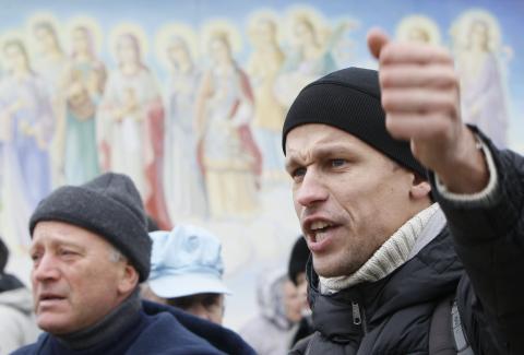 A man supporting EU integration shouts slogans during a rally in front of the Mikhailovsky Zlatoverkhy Cathedral (St. Michael's Golden-Domed Cathedral) in Kiev