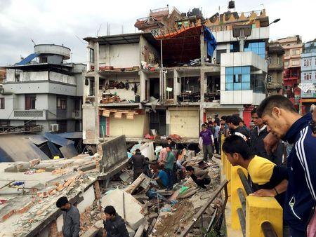 People survey a site damaged by an earthquake, in Kathmandu, Nepal, April 25, 2015. PHOTO BY REUTERS/Navesh Chitrakar