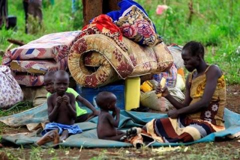 An elderly woman displaced by fighting in South Sudan rests by her belongings in Lamwo after fleeing fighting in Pajok town across the border in northern Uganda, April 5, 2017. PHOTO BY REUTERS/James Akena