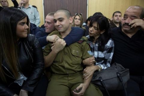 Israeli soldier Elor Azaria, who is charged with manslaughter by the Israeli military, sits to hear his verdict in a military court in Tel Aviv, Israel, January 4, 2017. PHOTO BY REUTERS/Heidi Levine