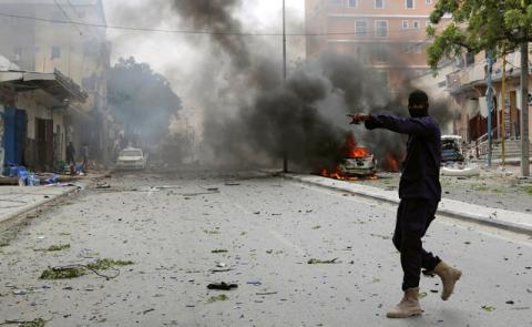 A Somali military officer secures the scene of an explosion in Maka al Mukaram road in Mogadishu, Somalia, July 30, 2017. PHOTO BY REUTERS/Feisal Omar