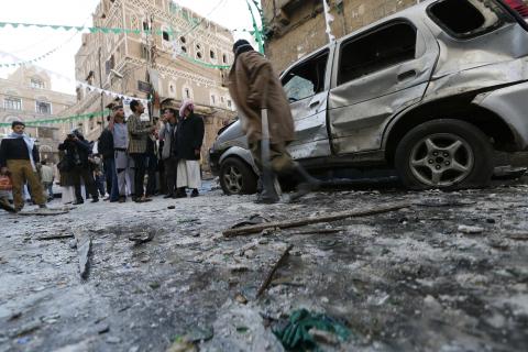 People gather at the site of a bomb explosion in Sanaa, December 23, 2014. PHOTO BY REUTERS/Khaled Abdullah