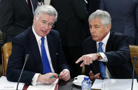 Britain's Defence Secretary Michael Fallon listens to U.S. Secretary of Defense Chuck Hagel (R) during a NATO defence ministers meeting at the Alliance headquarters in Brussels, February 5, 2015. PHOTO BY REUTERS/Francois Lenoir