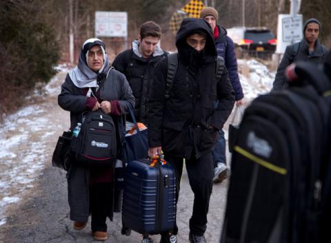 A group that claimed to be from Turkey crosses the U.S.-Canada border illegally leading into Hemmingford, Quebec, Canada, March 6, 2017. PHOTO BY REUTERS/Christinne Muschi