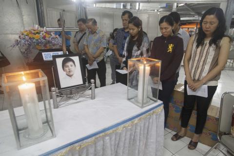 Family members of Grayson Herbert Linaksita, a passenger of AirAsia Flight QZ8501, attend his cremation at The Adijasa crematorium in Surabaya, January 2, 2015. PHOTO BY REUTERS/Sigit Pamungkas