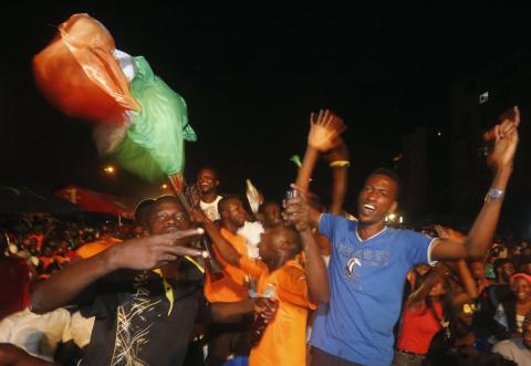 Fans of Ivory Coast's soccer team celebrate their team winning their 2015 African Nations Cup semi-final soccer match against Democratic Republic of Congo, along a street in Abidjan, February 4, 2015. PHOTO BY REUTERS/Thierry Gouegnon