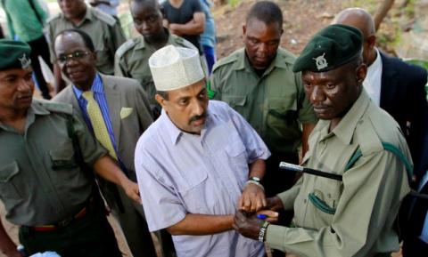Suspected Kenyan ring-leader of an ivory smuggling gang Feisal Ali Mohamed, also one of the nine most wanted environmental crime fugitives worldwide listed by Interpol, is escorted after the judgment on a case in which he had been charged with dealing and possession of 2,152 kg of ivory in Mombasa, Kenya, July 22, 2016. PHOTO BY REUTERS/Joseph Okanga