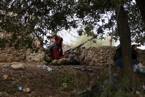 Turkish-backed Free Syrian Army fighter talks on a mobile phone in Northern Afrin countryside, Syria, February 16, 2018. PHOTO BY REUTERS/Khalil Ashawi