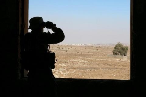 A rebel fighter looks through binoculars in Quneitra countryside, Syria, September 10, 2016. PHOTO BY REUTERS/Alaa Al-Faqir