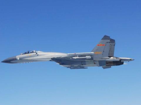 A Chinese SU-27 fighter flies over the East China Sea, in this handout photo taken May 24, 2014 and released by the Defense Ministry of Japan