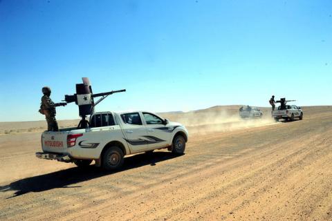 Forces loyal to Syria's President Bashar al-Assad ride on pick-up trucks mounted with weapons in the Badia, in the southeast Syrian desert, in this handout picture provided by SANA on June 13, 2017, Syria. PHOTO BY REUTERS/SANA